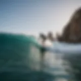 Scenic view of Cabo coastline with surfers in action