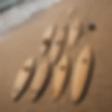 Various sizes of cardboard surfboard cutouts arranged creatively on a beach.