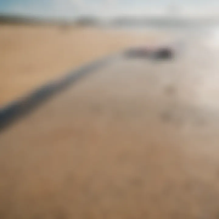 A close-up of a kitesurfing board on the sandy beach