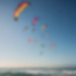 An assortment of kitesurfing kites in vibrant colors against a clear sky