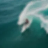 Aerial view of a surfer riding a wave at a Caribbean island