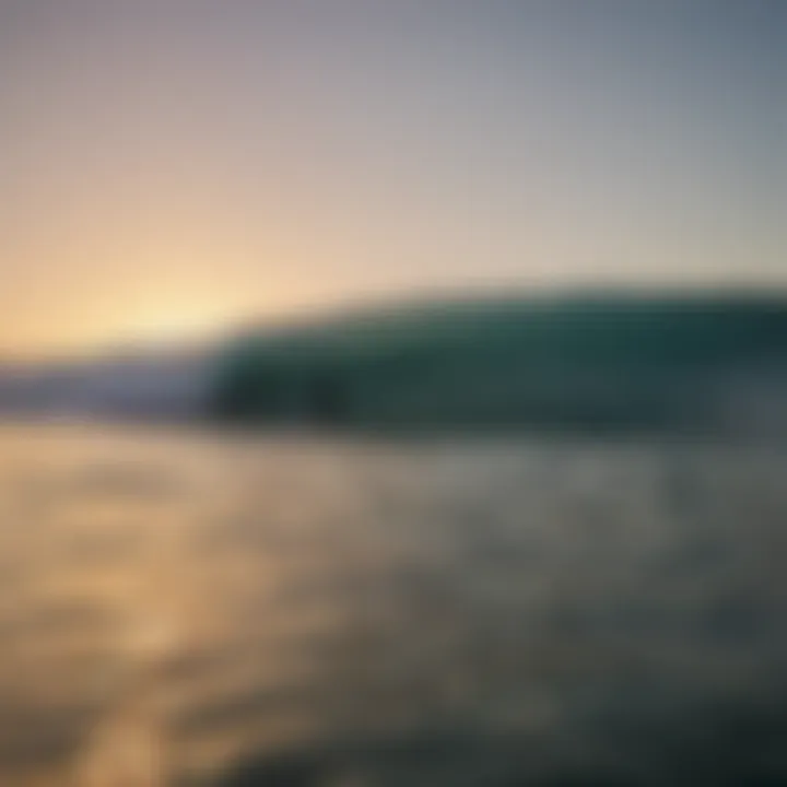 A lone surfer paddling out into a calm ocean during dawn