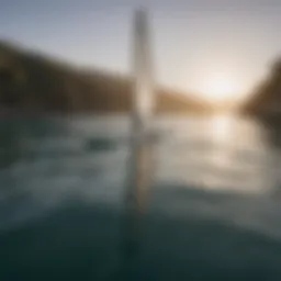 Stand up paddle board with sail gliding on water