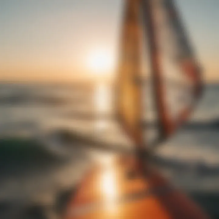 A close-up of windsurfing equipment set against a sunset backdrop, highlighting the artistry of the sport.