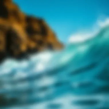 The Power of Ocean Waves Close-up of ocean waves crashing against rocky cliffs under a clear blue sky