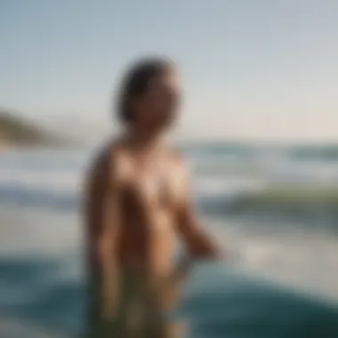 A surfer meditating on the beach, illustrating the mental aspect of balance.