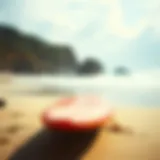 A vibrant soft top long surfboard on the beach