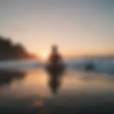 Meditative figure sitting near the ocean at sunset