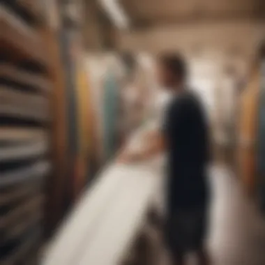 A surfer examining a second hand board in a shop