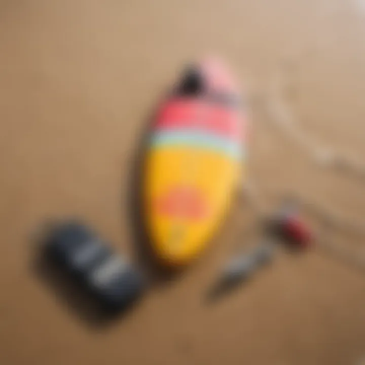 A vibrant surfboard resting on the sand next to a waterproof key case