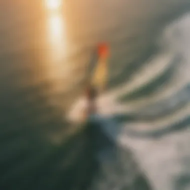 An aerial view of a kite surfer in action during sunset