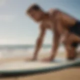 Surfer experiencing a muscle cramp on the beach