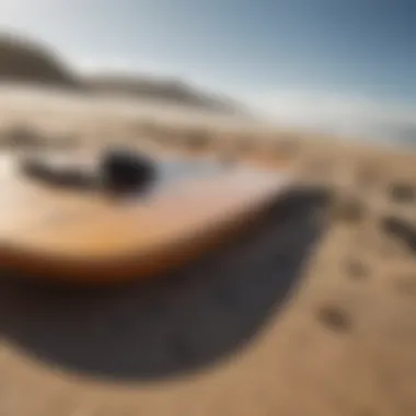 Close-up of essential skimboarding equipment laid out on the beach