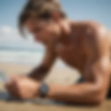 Surfer checking GPS watch while on the beach