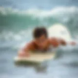 Surfer practicing swimming drills in the ocean
