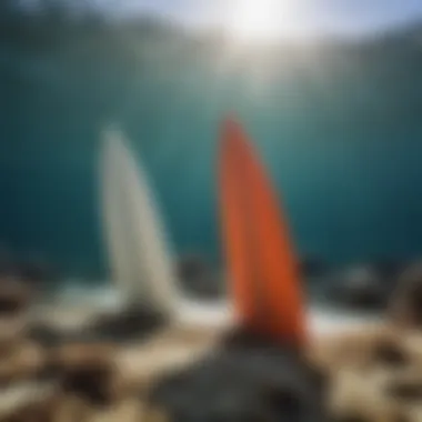 Close-up of surfboard fins interacting with coral reef water