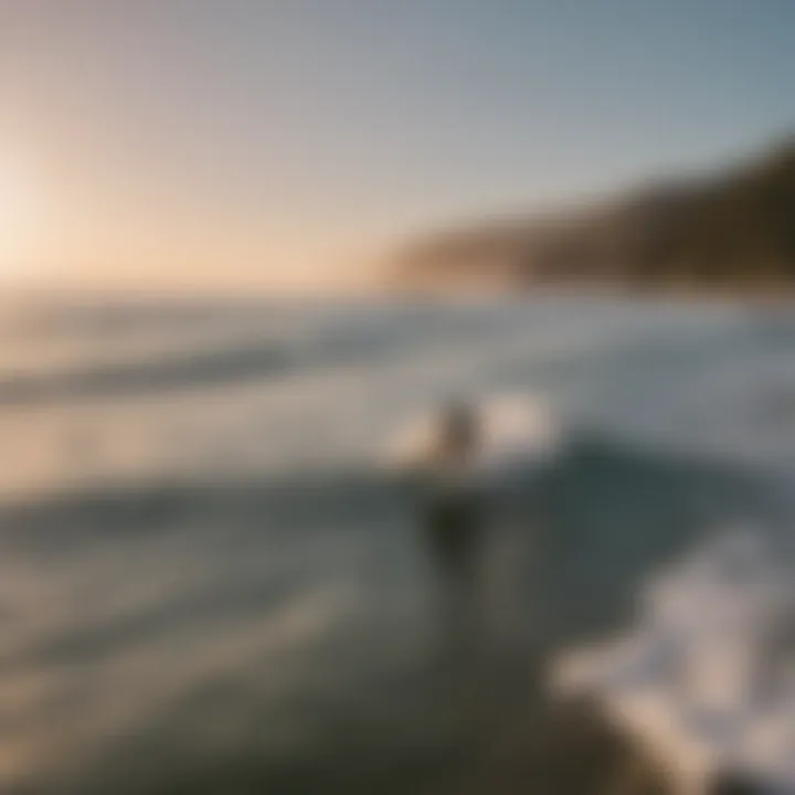 A serene ocean view with surfers riding the waves at sunset