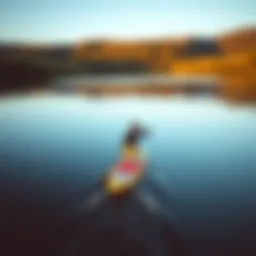 Serene paddle boarding on a tranquil lake at sunrise