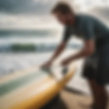 Demonstration of scraping wax off a surfboard