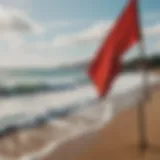 A vibrant red flag waving on a beach signaling danger.